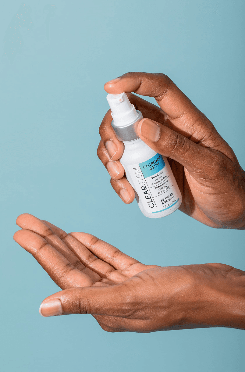 Hand dispensing Clearstem CellRenew Serum into another hand.