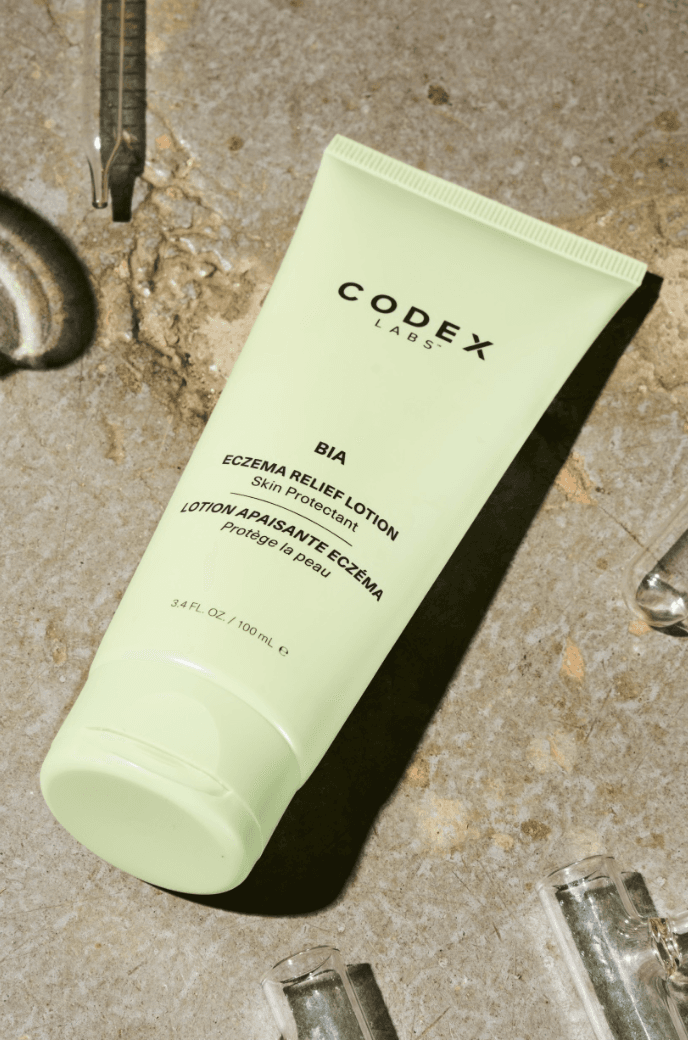 Codex Labs BIA Eczema Relief Lotion tube with small vials on a stone surface.